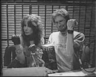 Portrait de la rockeuse Lee Aaron et de Steve Olson, de la station radiophonique CKXL de Calgary, au cours d'une entrevue en direct pour la promotion de son album Metal Queen [ca. 1984].