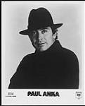 Close-up press portrait of Paul Anka wearing a hat. ICM / Columbia [ca. 1983].