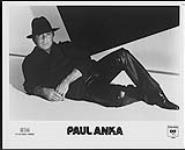 Press portrait of Paul Anka wearing a hat reclining. ICM / Columbia [ca. 1983].