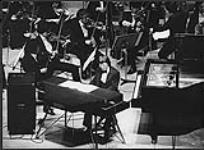 John Francis Arpin playing piano at the second International Original Concert held in Tokyo [ca 1982]