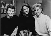 Portrait of Laurie Hibberd, host of YTV Rocks National Youth Channel. Two other young men are also pictured, one possibly Michael Quast ("Michael Q") [ca. 1990]