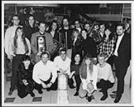 Group portrait of Barney Bentall and the Vancouver branch of his recording label holding awards [entre 1990-1997].