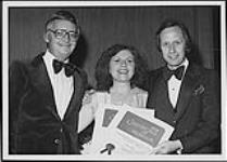 Portrait of Mary Bailey upon receiving her Certificate of Honour from the Performing Rights Organization of Canada Ltd. Also pictured are two unidentified men wearing tuxedos 1978