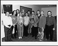 On Wednesday, July 10th, 1996, in a reversal of roles, Def Leppard present the PolyGram Group Sales staff with a platinum award for the album 'Slang' July 1996