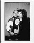 Celine Dion is presented an award for her album 'Falling into you' [ca 1996].