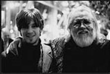 Ronnie Hawkins and an unidentified young man smile for the camera [between 1995-2000].