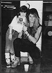 Sebastian Bach of Skid Row posing with a young girl [between 1987-1990].