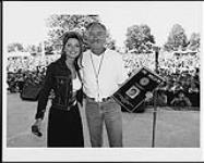 Shania Twain receiving a Diamond album award for "The Woman in Me" onstage at a concert August 17, 1996