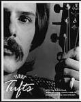 Photo publicitaire de Terry Tufts tenant une guitare [entre 1987-2000].