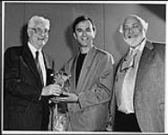 Gordon F. Henderson (Chairman of the PROCAN Board of Directors) presenting Crystal Awards to Ken Tobias, composer of "Every Bit of Love," and to Les Weinstein of Abovewater Publishing, co-publisher of the song [between 1975-1976].