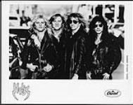 Portrait de presse des membres du groupe Helix, debout dans la rue, vêtus de vestes de cuir [between 1983-1990].