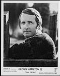 Press portrait of George Hamilton IV leaning against a wooden fence [between 1963-1970].