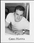 Press portrait of Greg Hanna wearing a white t-shirt [between 1995-2000].