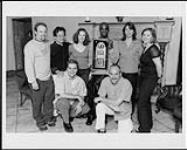 JOE receiving a gold album award from Zomba Canada staff, May 30, 2000: (l to r, back) Adrian Strong (Ontario Promo/Marketing Rep), Mike Wong (Director of Finance and Operations), Stephanie Robertson (National Director of Marketing), JOE, Laura Bartlett (President), Jane Tattersall (National Marketing Manager), (front row) Vlad Spirkoski (National Media-Artist Relations), Steve Coady (Director of Promotion & Media Relations) May 30, 2000