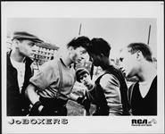 Press portrait of JoBoxers posed in a scuffle [between 1982-1985].