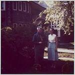 Sir Ernest MacMillan standing outside a house with a woman s.d.