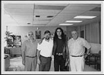 Daniel Lanois with three unidentified men [between 1987-1989].