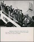 Refugees bound for Canada waving farewell as the board an airplane in Italy 1959