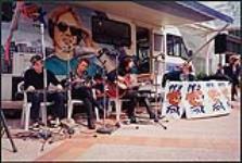 Members of The Tea Party perform live via the 99.3 The Fox mobile studio "The Fox Rock-it" and chat with announcer Bill Courage [entre 1995-2000]