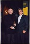 Gilles Vigneault holding the Wm. Harold Moon Award and standing beside Bill Henderson [ca 1996].