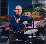 Rick Camilleri sitting at a drum set [between 1990-2000].