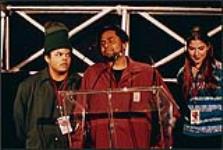Three unidentified people, one giving a speech at the Juno Awards ceremony [entre 1985-2000].
