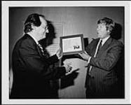 CMPA president, Greg Hambleton giving Mel Shaw the Canadian Music Publisher's Association (CMPA) award [between 1985-1988].