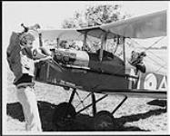 Brampton Flying Club was the setting for the signing between Tapestry Records and RCA records. Ed Preston of RCA sits in a vintage bi-plane, while Rick Butler of Tapestry Records, winds up July 5, 1979