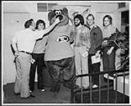 Sammy Jo Romanoff of RPM Magazine and Rob Meadows, with the A&W bear and three unidentified people [between 1970-1979].