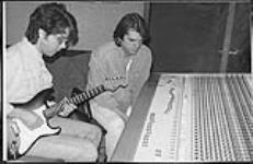 Gary F and Johnny Douglas at a mixing board [between 1985-1995].