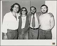 De gauche à droite : Mike Lembo (de Mike's Artist Management, New York), Malcolm Tomlinson, Gerry Lacoursiere (président, A&M Records Canada), Mike Bone (de Mike's Artist Management, New York) [between 1984-1985].