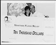 Michelle Wright holds an oversized cheque of 10,000 dollars for Manitoba Flood Relief June 1997