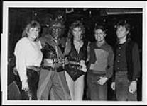 Winners of the "Warriors Ball" costume contest sponsored by Toronto's Q-107 for Attic recording artists, Warriors, collect their prizes 1985