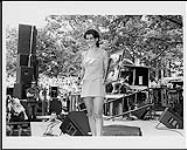 Michelle Wright shares her Gold album award with the CISS-FM Canada Day Crowd [ca 1996].