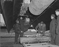 [Canadian groundcrew refuel and bomb-up an RCAF heavy bomber in Britain] [1944].