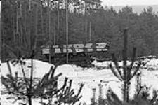 Ex Certain Sentinel, FRG. A Leopard bridge layer in pine woods during exercise February 1979.