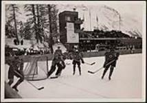 The RCAF Flyers hockey team in action against Sweden's national men's hockey team at the 1948 Winter Olympic Games in St. Moritz, Switzerland 30 January 1948.