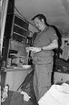 Fall Ex. Germany. Cpl. Desmarais sorting mail in back of 2 1/2 ton van during Fall training at Hohenfels September 1977.
