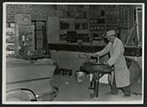 [Man working in garage, Bill Youngson] [ca. 1955]