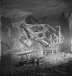 A large electric shovel loading ore under the Conception Bay ore face in Bell Island 1949