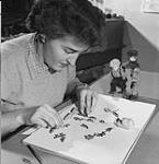 Eve Lambert designing a puppet 1950