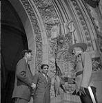 Muhammad Munir, left, Mohammed Abdus Sattar, centre, and RCMP Constable A. E. McRae in front of the Parliament buildings 1954