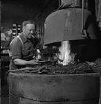 Harper Rennick heating a horseshoe 1956