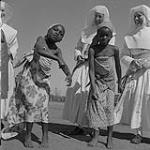 Sister Imelda, left, and Sister Marie de Fatima and young girls performing a traditional dance 1957
