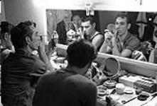Male members of the National Ballet of Canada apply make-up prior to the evening performance at the Grand Theatre février 1958