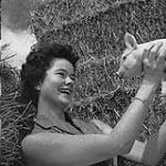 Norma Dewar holding a Yorkshire piglet 1958