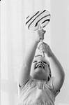 Diane Lunney holding a peppermint lollipop 1959