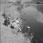 Children playing by a pond 1959