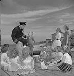 Skipper Peter Troake speaking to a group of children 1960