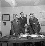 Professional technicians signing contract February, 1967